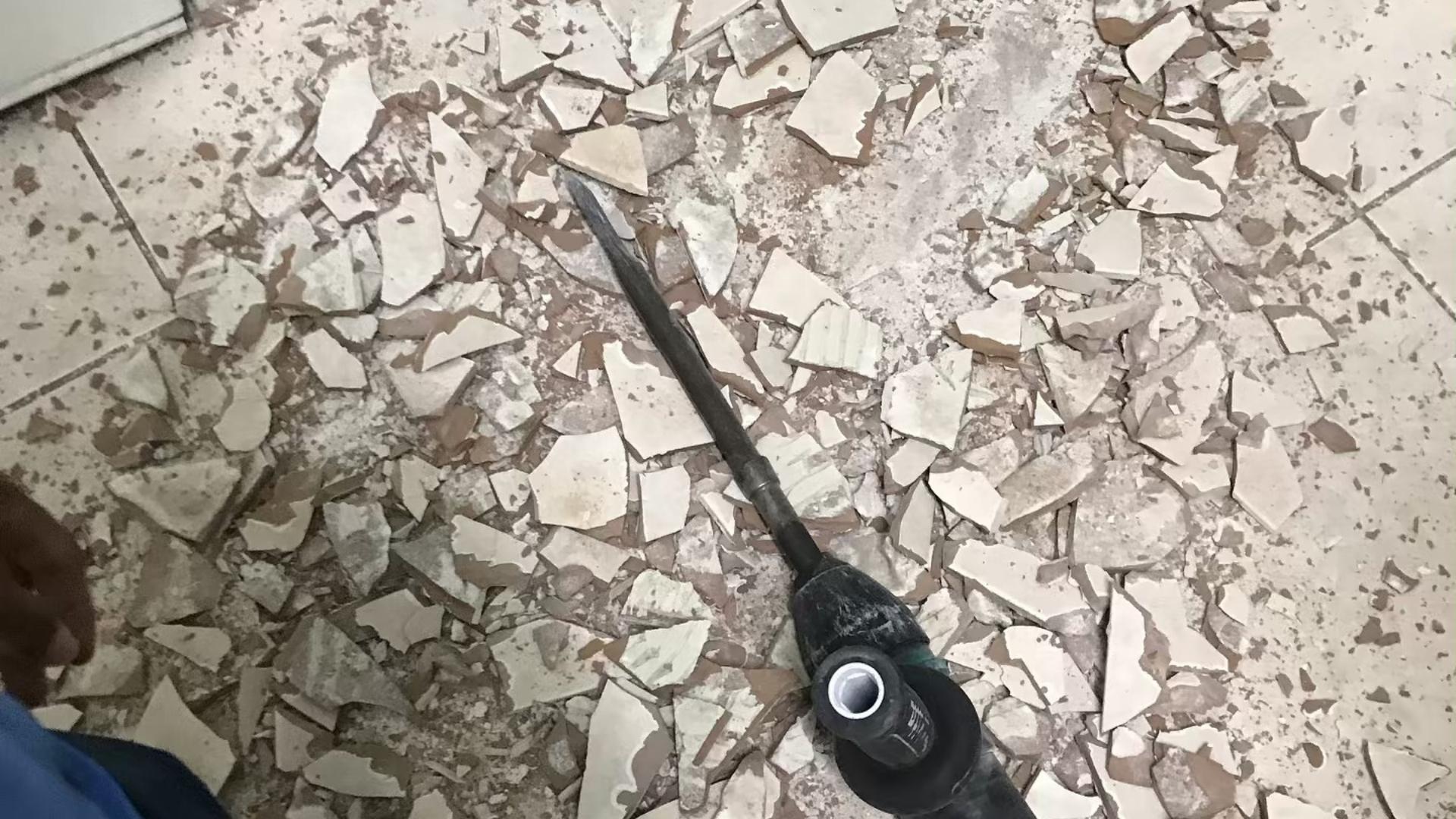 Old ceramic floor tile broken up during a demolition and removal job